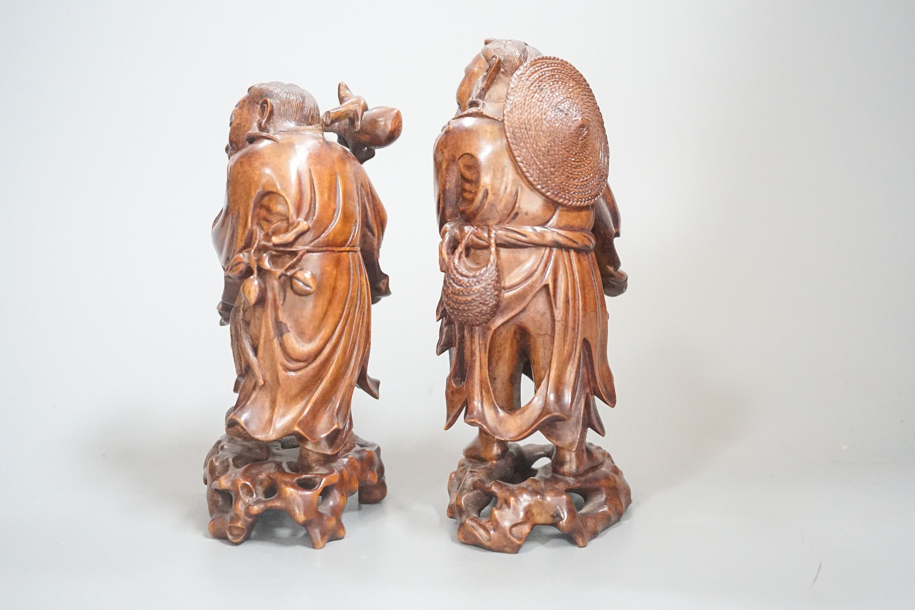 Two Chinese hardwood figures of a fisherman and a old man holding peaches 16cm